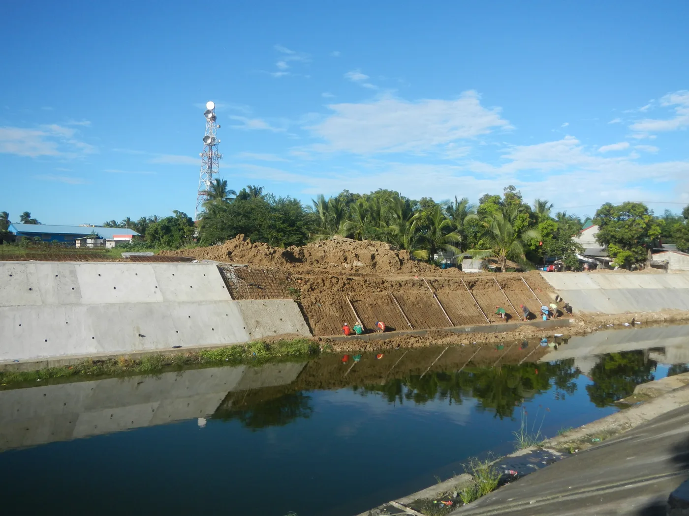Retaining-wall and slope-protection work beside a river in Bulacan